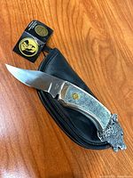 Knife with pouch and Franklin Mint tag visible