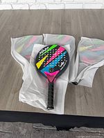 Three paddles on table, two partially wrapped, one fully visible