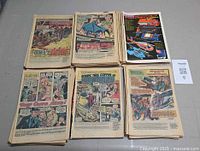 Six open coverless comics showing interior pages, advertisement insert, and romance, horror, superhero content