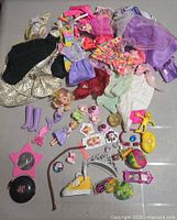 Full lot overview showing pile of clothing and scattered accessories