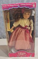 Full view of boxed porcelain doll front