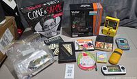 Overview of all items including microscope set, board games, card games, electronics