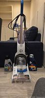Front view of Hoover carpet cleaner with two cleaner bottles