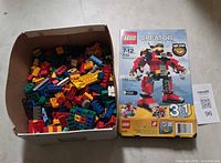Set box and box of assorted bricks side by side