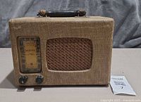 Front view showing tuning dial, speaker grille, knobs