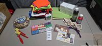 Overall lot showing felt, glue, beads, brushes, canvases, paint, rope, photo paper