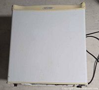 Top view of mini fridge showing exterior and brand badge