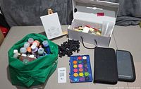 overall lot view showing paints, easels, canvas, craft box, watercolour palette and cases