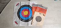 All targets laid out: Morrell reusable target, two Champion packs, beige bullseye targets