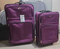 Both purple suitcases side by side
