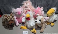 Front group view of seven Webkinz plush animals