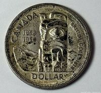 Reverse of 1958 Canadian silver dollar showing totem pole design and dates 1858-1958