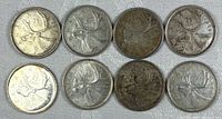 Eight Canadian 1965 quarters displayed obverse up showing caribou design
