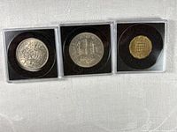 Front view of three 1967 coins in holders