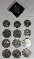 Overview showing 8 Voyageur dollars and 5 fifty-cent coins