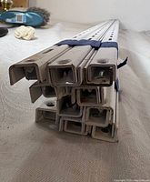 Bundle of white slotted steel uprights stacked