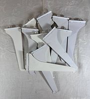 Top view of stacked white metal shelf brackets