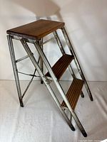 Full view of folded-out metal and wood step stool