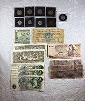 Group overview of all banknotes and coins laid out on table