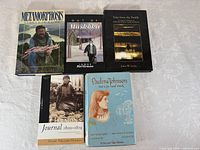 Five books laid out on table showing front covers and titles
