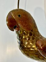 Close-up of parrot head showing brass and copper detailing