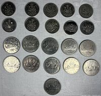 All coins laid out, obverse and reverse visible showing denominations and dates