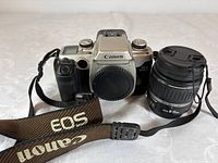 Front view of Canon EOS Elan II body with strap and Canon EF-S 18-55 mm lens