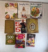 All nine cookbooks laid out showing covers