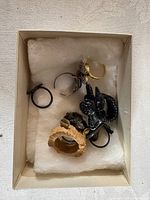 Box showing nine assorted rings