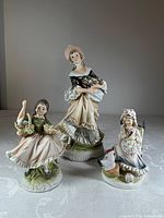 Front view of all three L'Amour China figurines