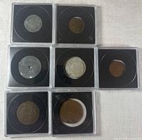 Seven encased coins in holders