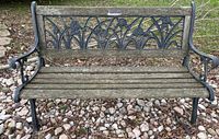 Full view of garden bench front showing wood slats and floral cast iron backrest