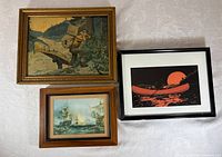 All three framed artworks laid out together