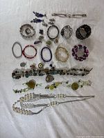 Entire assortment of jewelry laid out on cloth