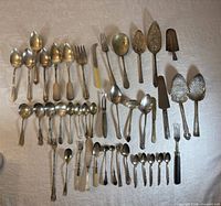 Entire assortment laid out showing variety and count of utensils