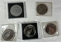 Five coins in holders showing obverse designs