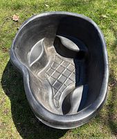 top view of black molded pond basin showing interior shelves and textured floor