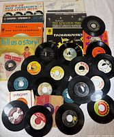 Group shot of 7 LP jackets with spread of 24 loose 45-rpm singles
