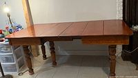 Dining table fully extended showing top and legs