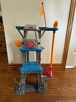 Front view of three-level Rescue Heroes command center playset with rescue pole and flag