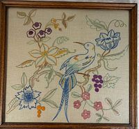 Front view of framed embroidered bird and floral needlework