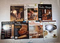 Seven woodworking magazines laid out