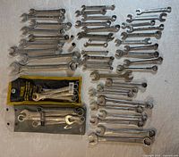 Wide shot of all loose wrenches plus packaged sets laid out for size and condition reference