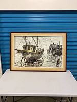 Front view of framed maritime painting showing boat, pier and full frame
