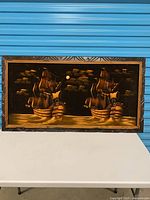 Front view showing full artwork with two sailing ships and carved frame