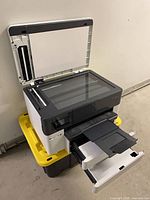 Printer open showing scanner bed and paper trays