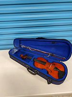 Open hard case showing violin and bow