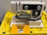 Front view of Baycrest sewing machine with instruction book