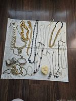 Entire lot laid out on cloth showing all jewelry pieces