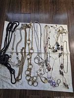All thirteen necklaces laid out on cloth showing full assortment